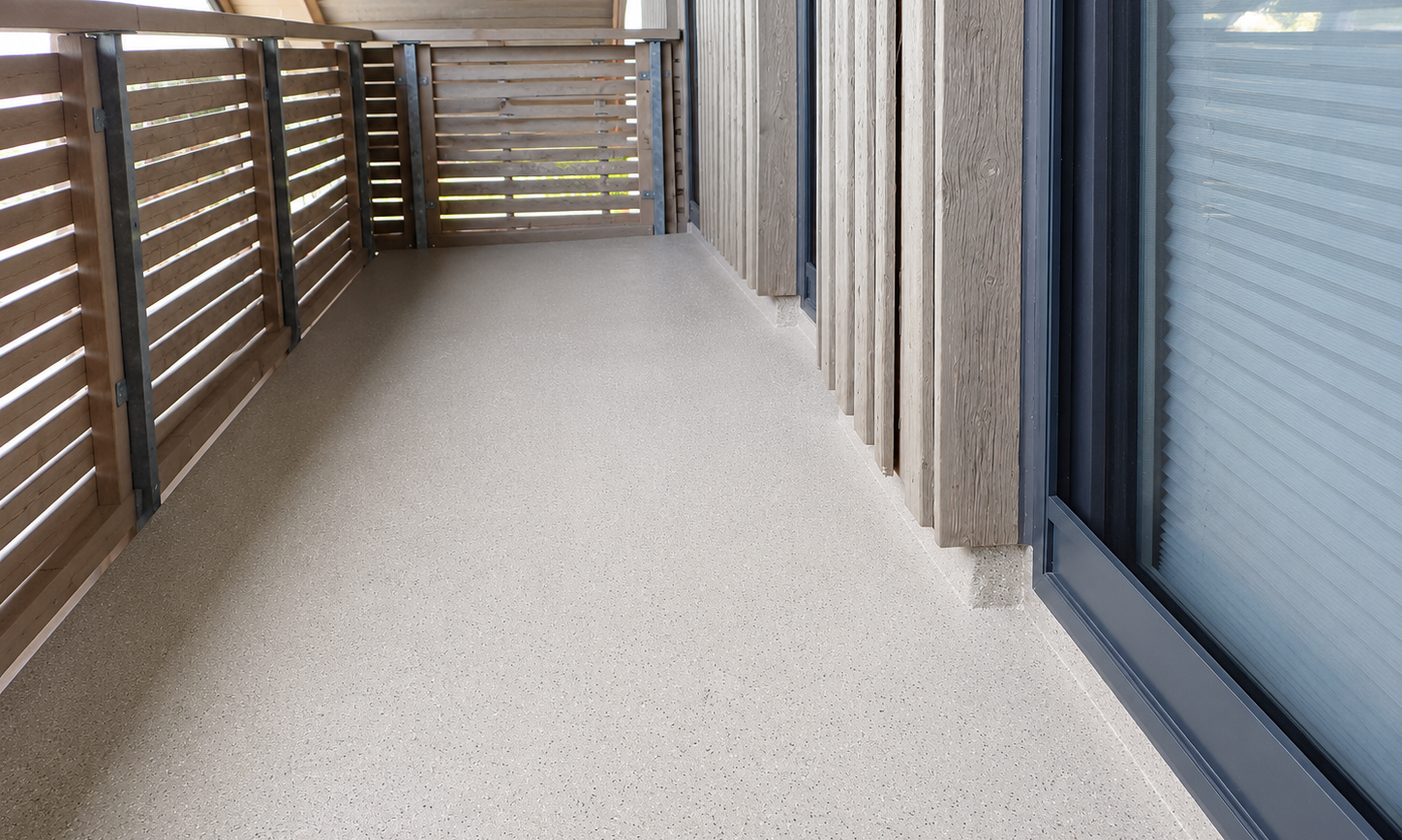 Balkon mit grau gesprenkeltem Boden, Holzlamellen und Schiebetür