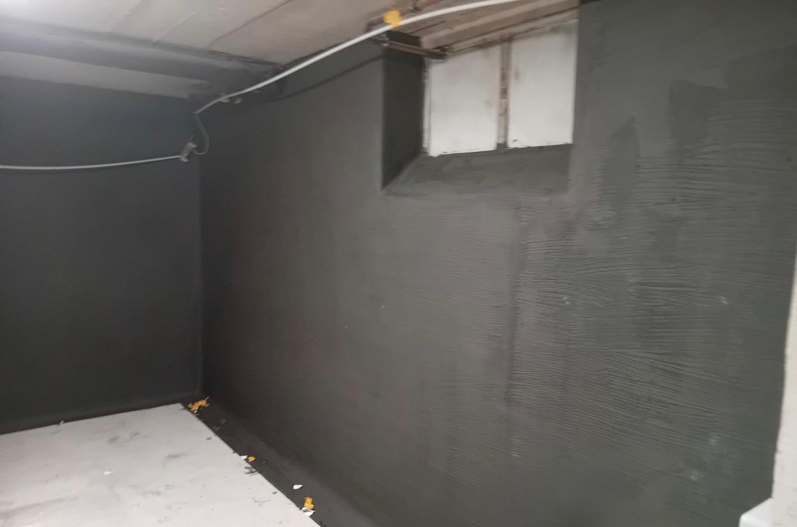 Schwarze Masse auf Kellerwand, Leitungsführung an der Decke und Fensternische.
