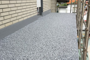 Marmorkieselbelag für den Balkon Ein Steinteppich aus Marmorkiesel bildet die Oberfläche eines Balkons